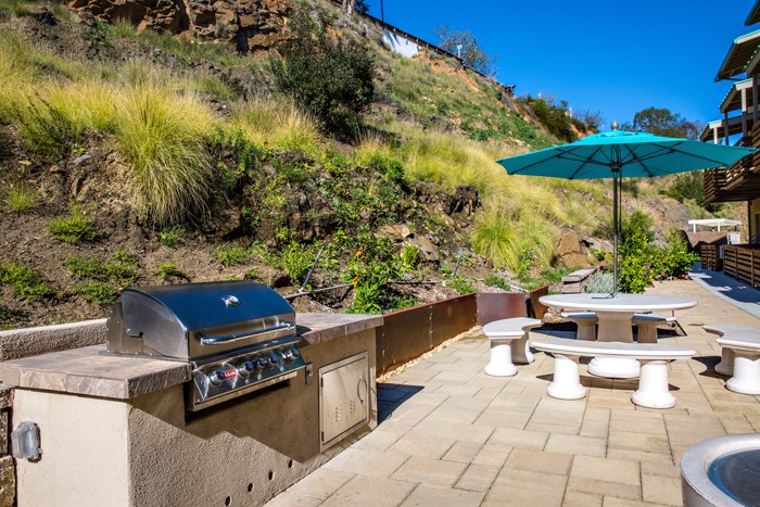 The community boasts an elevated courtyard with a barbecue and parking with carports.